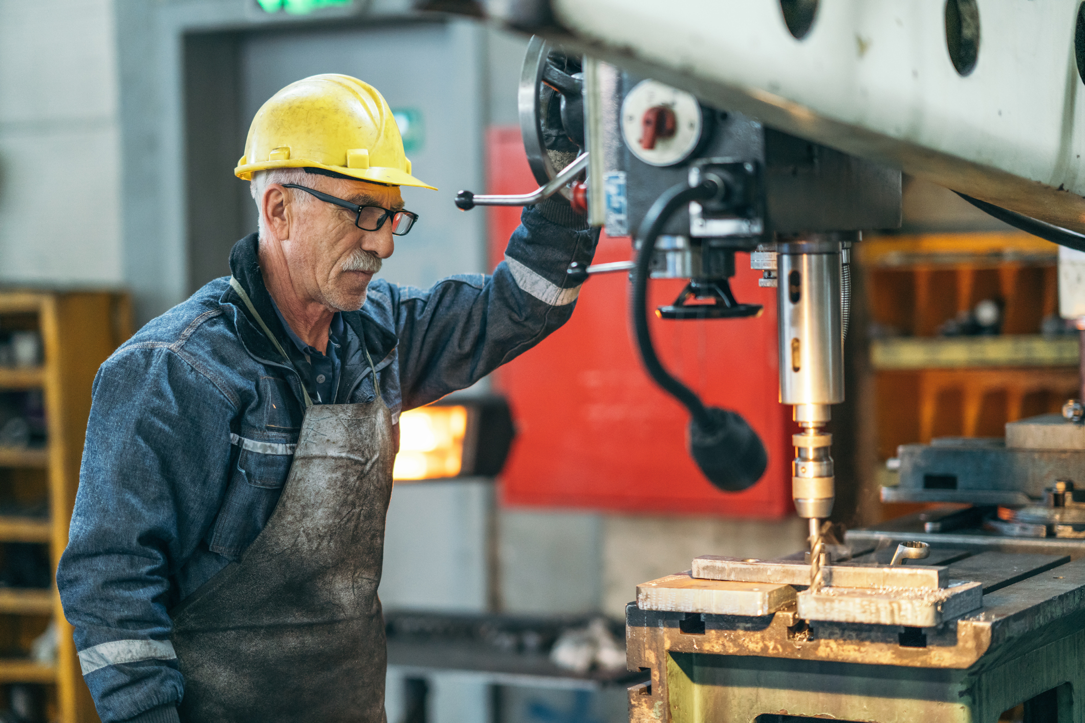 Turner worker working on drill bit in a workshop